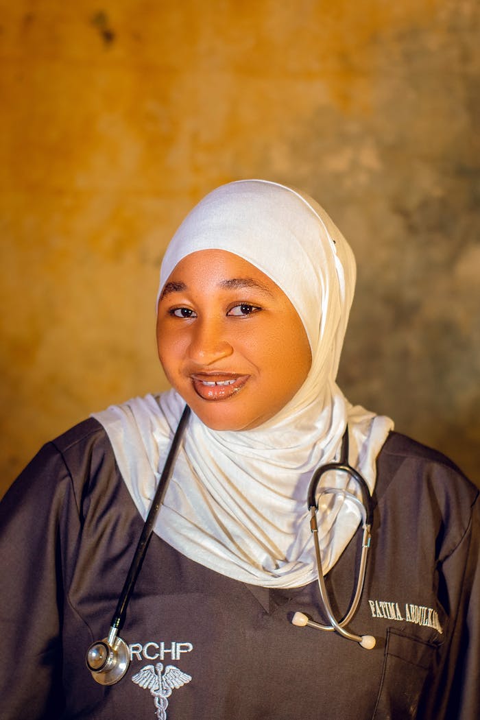 Portrait of a smiling healthcare professional in uniform with a stethoscope.